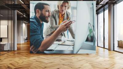 Business startup concept.Young man working together with partner in modern office loft Wall mural