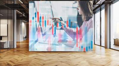 Business woman and her collegue sitting front laptop computer with financial graphs and statistics on monitor. Double exposure. Wide Wall mural