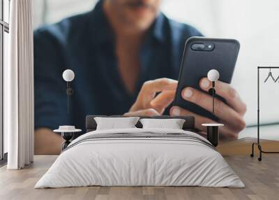 Close-up photo of male hands with smartphone Wall mural