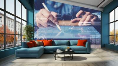 Concept of virtual diagram,graph interfaces,digital display,connections icon.Man using stylus pencil on display of contemporary electronic tablet.Blurred background. Horizontal. Wall mural