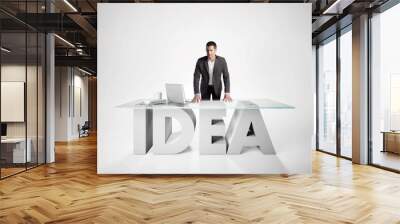 Portrait of a businessman leaning on IDEA table Wall mural