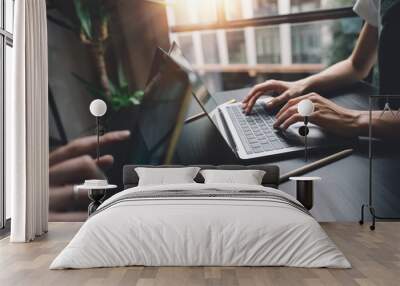 Woman hands typing on laptop keyboard at the office Wall mural