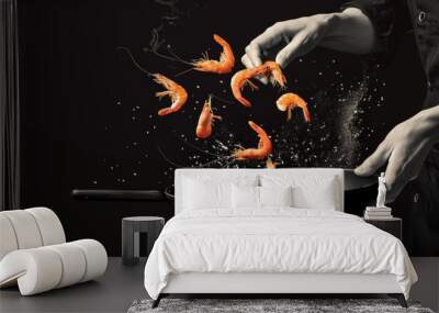 A chef is cooking shrimp in a pan and the shrimp are falling out of the pan Wall mural