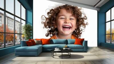 A young girl with curly hair is smiling and laughing Wall mural