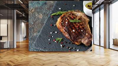 steak grilled beef entrecote on bone on dark slate background. stone slate for feeding meat. Wall mural