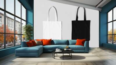 White and black tote bags mockup on a grey background. Wall mural