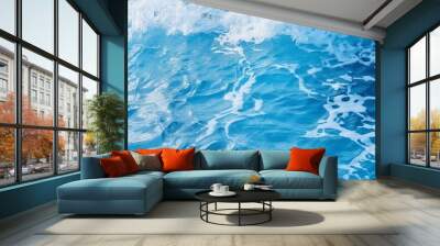 Abstract background of fast stream of water splashing in blue sea with waves on daytime Wall mural