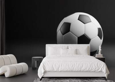 A classic black and white soccer ball resting on a smooth surface in low light environment Wall mural