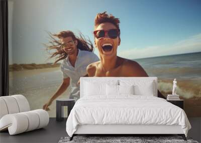 A joyful young couple enjoying themselves on a sunny day at the beach. Wall mural