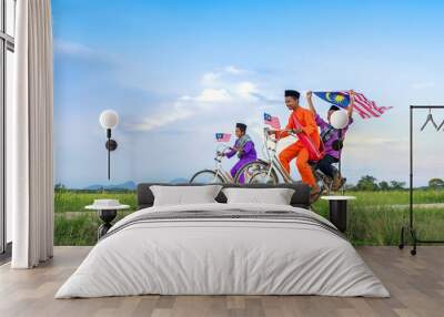 independence Day concept - Two happy young local boy riding old bicycle at paddy field holding a Malaysian flag Wall mural