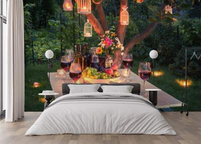 Beautiful table full of wine, cheese and snacks at dusk Wall mural