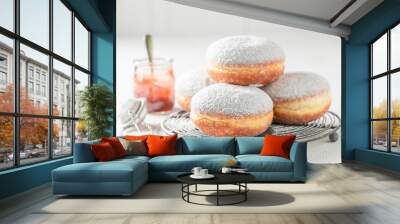 Closeup of tasty donuts with powdered sugar on white table Wall mural