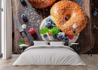 Delicious bagel with raspberries and blueberries for healthy breakfast Wall mural