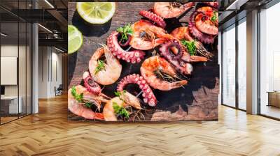 Fresh skewers of seafood with lemon and parsley in garden Wall mural