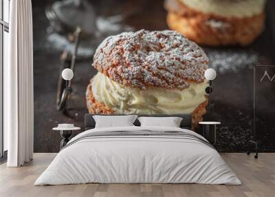 Tasty and homemade cream puffs with powdered sugar in strainer. Wall mural