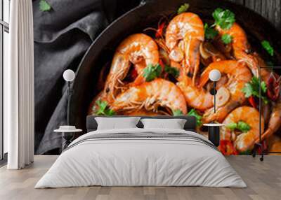 Tasty shrimps on pan with garlic, coriander and peppers Wall mural