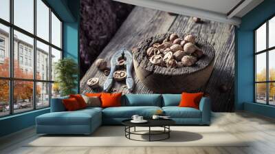 Walnuts and hazelnuts with with old nutcracker Wall mural