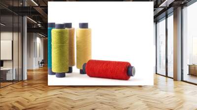 spool of sewing thread used in fabric and textile industry, different colors, isolated on white background Wall mural