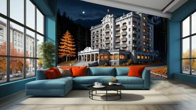 luxury hotel resort at the base of a mountain in the yellow orange autumn woods at night. modern baroque architecture building in the woodland wild forest mountains. Wall mural