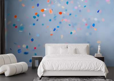 Colorful confetti falling on a holiday on a blue background Wall mural