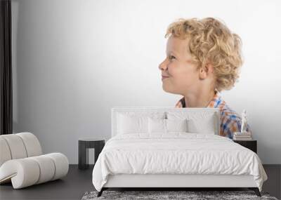 Profile of smiling, curly haired, blonde boy on white background Wall mural