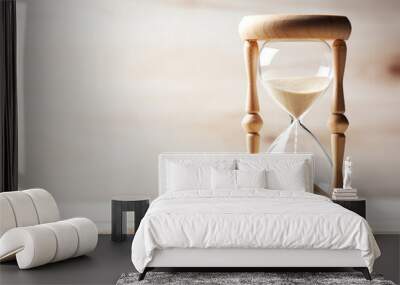 Classic wooden hourglass on wooden table. Wall mural