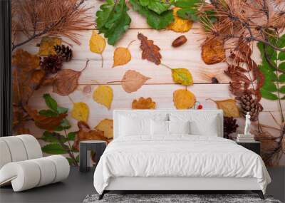 Dry and fresh green leaf frame on wooden background. Autumn seasonal banner template backdrop. Rustic flat lay. Dry leaf decor. Orange leaf texture. Fall season top view Wall mural