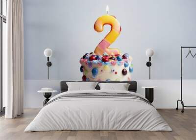  a birthday cake with a candle in the shape of the number two on it's top and sprinkles on the bottom of the cake, on a white plate. Wall mural