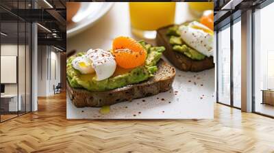  a close up of two pieces of bread with avocado, oranges, and whipped cream on them. Wall mural