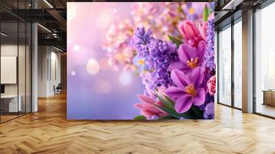   A purple and pink flower arrangement on a blue and pink backdrop with a blurry boke of light Wall mural