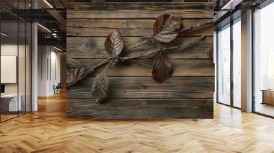   A zoomed-in image of a tree branch with foliage resting on a brown board surrounded by a black border Wall mural