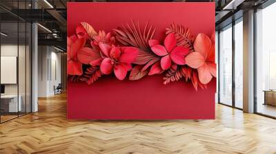   Close-up of vibrant flowers on a bright red backdrop, adorned by a row of lush green foliage Wall mural