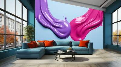  two purple and pink tubes of liquid on a blue background with a drop of water in the middle of the image. Wall mural