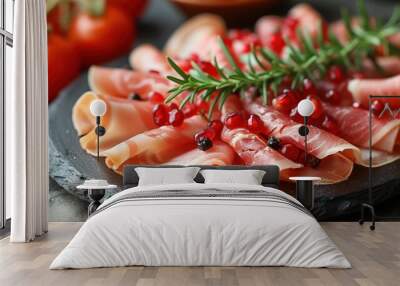 a close up of a plate of food with meat and veggies on a plate with a sprig of rosemary. Wall mural