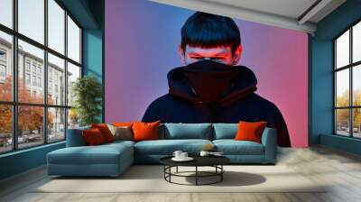 young man with black  mask on color background  Wall mural