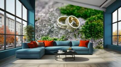 wedding rings on tree with green moss. Wall mural