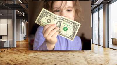 Young kid girl holding money in hands Wall mural