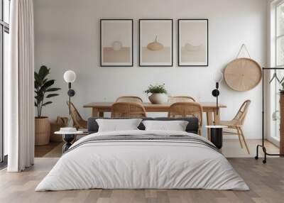 A minimalist dining room with a wooden table, two wicker chairs, and three empty frames on the wall. Wall mural