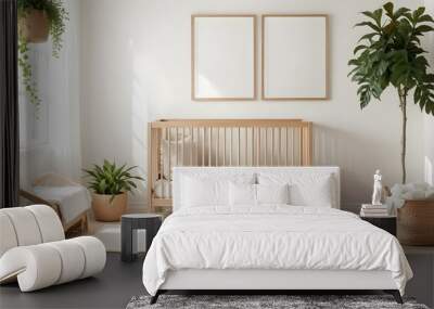 A wooden baby crib with a neutral-colored mattress and bedding, two empty wooden frames on the wall, and a potted plant in the background. Wall mural