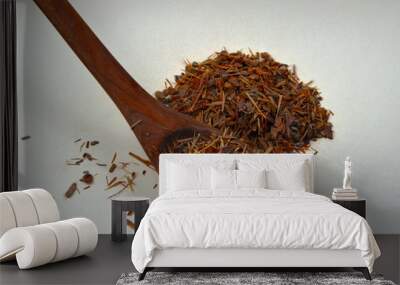 Catuaba bark and wooden spoon with catuaba on white background Wall mural