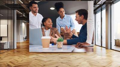 Business people, laptop and meeting for team building, collaboration or fun planning and strategy at office. Happy group of creative employees discussing project plan in friendly teamwork for startup Wall mural