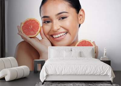 Happy woman, portrait and grapefruit for skincare vitamin C, beauty or cosmetics against a white studio background. Female person smile with fruit in healthy nutrition, natural healthcare or facial Wall mural