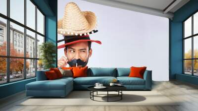 Photo booth mockup, hat and face of man in studio with mustache for comic, humor and funny joke. Happy, Mexican party accessory and excited male person on gray background with sombrero for comedy Wall mural