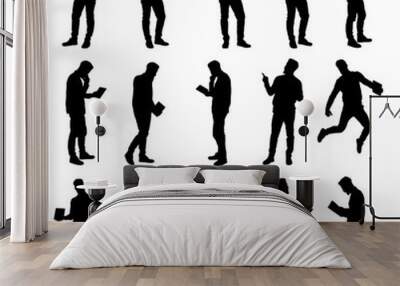 Set of working business man using laptop and tablet silhouettes. Easy editable layered vector illustration. Wall mural