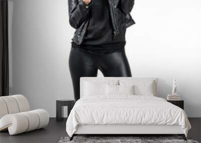 Sexy beauty wearing black leather and boots holding handgun with two finger peace hand gesture. Full body length portrait isolated over white studio background. Wall mural