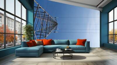 Transmission power lines tower over clear blue sky Wall mural