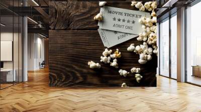 Movie tickets and popcorn on dark wooden table background. Home theatre movie or series night concept. Flat lay top view from above with copy space Wall mural