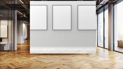 Three white empty blank picture or poster frames template mock up design hanging on white wall and wooden floor background in room with black frame Wall mural