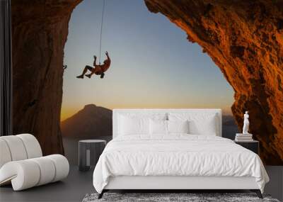 Silhouette of a climber falling on a rope above the Mediterranean sea with another island in view..  Wall mural