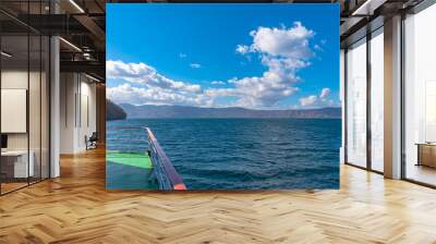 Lake Towada Sightseeing Cruises. Beautiful view, clear blue sky, white cloud, cruise ship in sunny day with autumn foliage season background. Towada hachimantai National Park, Aomori Prefecture, Japan Wall mural